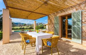 a table and chairs on a patio with a view at Pedra Viva in Son Servera