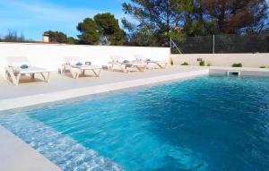 a swimming pool with chairs and blue water at Calma De Son Serra De Marina in Son Serra de Marina +29 photos