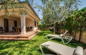 a yard with chairs and a house at Calma De Son Serra De Marina in Son Serra de Marina