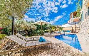ein Swimmingpool mit Terrassenmöbeln und einem Sonnenschirm in der Unterkunft Mofares in Calvià