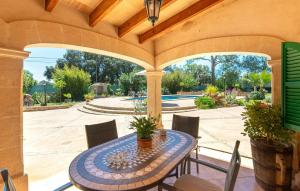 an outdoor patio with a table and chairs at Es Campets in Sencelles