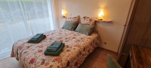 a bedroom with a bed with two bags on it at Gîte-La mare aux étoiles in La Douze +14 photos