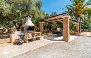 a outdoor grill with a table and a grill at Bosco in Sa Coma