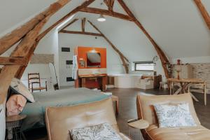 a bedroom with a bed and a couch in a room at Les Hauts de Bagadou in Martel
