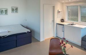 a small room with a bed and a sink at Beach Front Home In Samsø With House Sea View in Kolby Kås