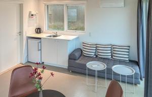 a living room with a couch and a table and chairs at Beach Front Home In Samsø With House Sea View in Kolby Kås