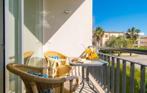 a balcony with a table and chairs on a balcony at Mirella in Pollença