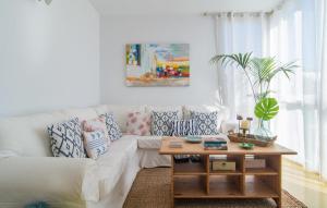 a living room with a white couch and a coffee table at Mirella in Pollença