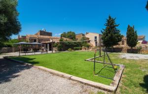 a playground in a yard with a swing at Son Favar in Capdepera +44 photos