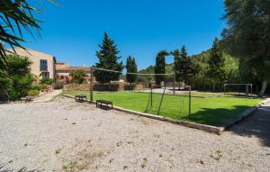 a park with a net and benches on a field at Son Favar in Capdepera