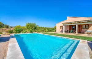 a swimming pool in front of a house at S'hortet Gran in Alcudia