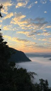 a view of the ocean with clouds in the sky at Papae viewpoint with camping in Ban Ngoy-Nua +6 photos