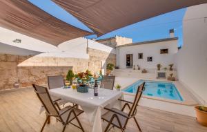 a patio with a table and chairs and a swimming pool at Foners Mallorquins in Muro