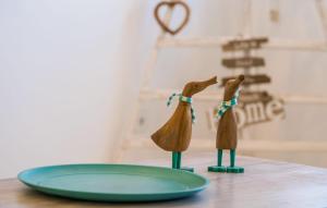 two wooden animals on a table next to a plate at Foners Mallorquins in Muro +44 photos