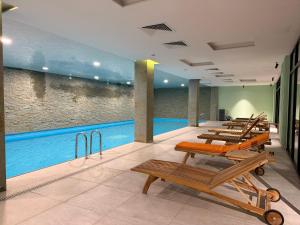 a row of chaise lounges next to a swimming pool at New Gudauri Studio N207 in Suites! in Gudauri
