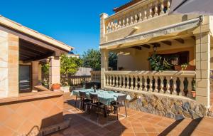 a patio with a table and chairs on a house at Manrique in Cala Ratjada