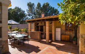 a patio with a kitchen and a table with chairs at Manrique in Cala Ratjada