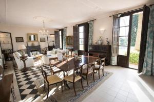 a living room with a dining room table and chairs at Catalunya Casas Impressive and Idyllic mansion for up to 40 people! in Banyeres del Penedes
