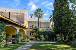 an exterior view of a building with trees and grass at Catalunya Casas Impressive and Idyllic mansion for up to 40 people! in Banyeres del Penedes