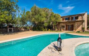 a bottle of wine sitting next to a swimming pool at Mirabo Ramonet in Felanitx
