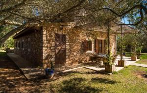 a stone house in a yard with a tree at Mirabo Ramonet in Felanitx +29 photos