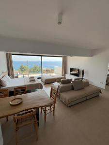 a large living room with two beds and a couch at Apartments-M4 in Neos Marmaras