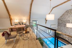 a room with a table and chairs and a brick wall at Les Hauts de Bagadou in Martel