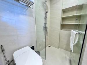 a bathroom with a toilet and a glass shower at Skypark New Building 4th floor Mountain View in Laguna Phuket +4 photos