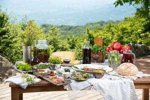 a picnic table with plates of food on it at Penzion Sinji vrh in Zoll
