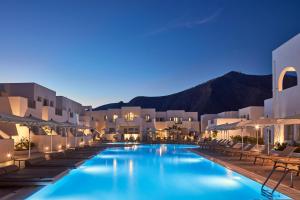 a view of a hotel swimming pool at night at Aqua Blue Beach Hotel in Perissa