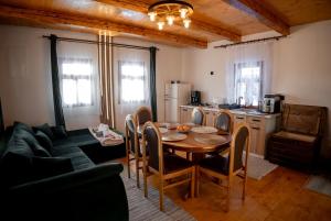 a kitchen and dining room with a table and chairs at The Forest Nest in Dealu Armanului