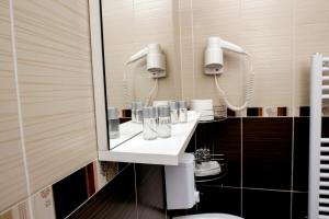 a bathroom with a sink and a mirror at Pensiunea Siva in Horezu +27 photos