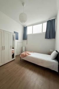 a bedroom with a large bed with blue curtains at 2Stay Porto in Porto