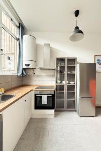 a kitchen with white cabinets and stainless steel appliances at 2Stay Porto in Porto +33 photos
