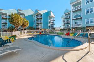 a swimming pool with a slide in front of some apartment buildings at Baywatch C10 in Pensacola Beach