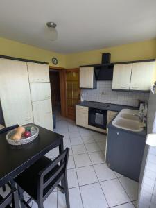 a kitchen with a table with a bowl of fruit on it at LOGEMENT 110m2 CHEZ TITI in Ittenheim