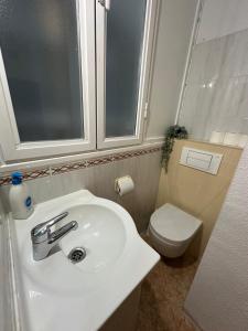 a bathroom with a white sink and a toilet at Center Madrid habitaciones in Madrid +46 photos