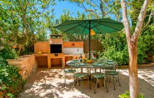 a table and chairs under a green umbrella at Pambola in Caʼs Concos +30 photos
