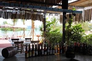 a bar with bottles of wine on a table at Koh Pu Villa in Ko Jum