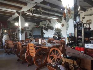 a dining room with a table and some wine bottles at Podgorski An in Kolešino