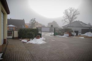 a driveway with snow on the ground in a house at Ferienwohnungen Alte Molkerei in Kläden