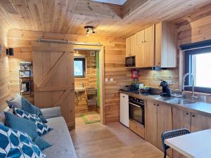 a kitchen and living room in a log cabin at La Bucolique de Tahier in Ohey