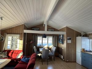 a kitchen and living room with a table and a refrigerator at Mountain cabin in Lillehammer in Lillehammer