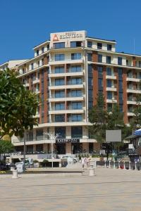 a large building with a sign on top of it at Pine Residence Zlatibor in Zlatibor