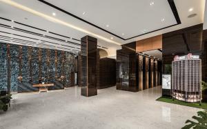 a lobby of a building with a wall of wine bottles at Centre Point Da Nang City Hotel - Afternoon Tea Inclusive in Danang
