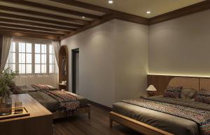 a bedroom with two beds and a table and a window at Voi Meo Vac Hostel & Breakfast in Mèo Vạc