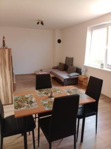 a living room with a table and chairs and a couch at APARTMÁN KATKA Stošice - Liptovský Mikuláš, súkromie & pohodlie in Liptovský Mikuláš +6 photos