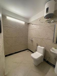 a bathroom with a toilet and a sink at Basera by the Woods in Dehradun +34 photos
