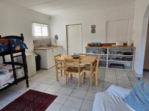 a kitchen with a table and chairs in a room at Driftwood Haven in Mossel Bay