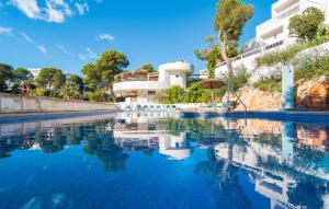 a pool of water in front of a building at Playa D'or in Cala d´Or